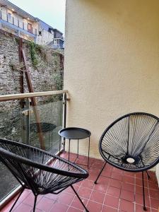 a black chair and a table on a balcony at Terrace Apartment X91 RR04 in Waterford