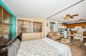 a bedroom with a bed and a living room at Sunset Beach Bungalow 3 in St. Pete Beach
