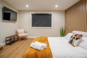 a bedroom with a large white bed and a television at Serene 1 bed guest house with patio sleeps 6 in Los Angeles