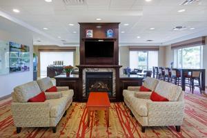 a living room with two chairs and a fireplace at Best Western Plus Muskoka Inn in Huntsville