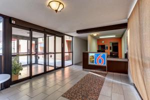 a lobby with a television in a building at Motel 6 Jackson, TN in Jackson