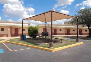 a picnic shelter in a parking lot in front of a building at Rodeway Inn San Antonio Lackland AFB - SeaWorld in San Antonio