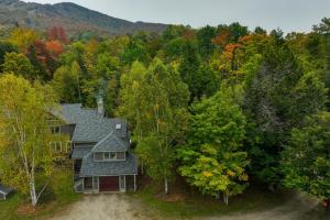 an aerial view of a house in the woods at Ski-in Condo with Hot Tub on Burke Mtn Slopes! in East Burke