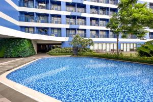 a large swimming pool in front of a building at Newly Turned 0ver Cond0- Air Makati 1BR with Balcony in Manila