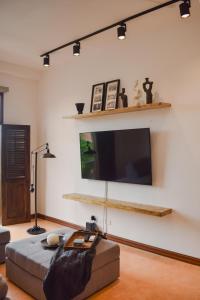 a living room with a bed and a flat screen tv at Amazing location Spacious Apto with Rooftop in Panama City
