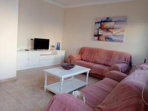 a living room with a couch and a coffee table at Casa Carmen Dolores in Caleta de Sebo