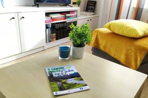a book sitting on top of a coffee table at Fogar do Vento-Ordes, cerca de Camino Inglés Bruma in Ordes