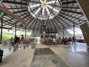 a group of people walking around in a building at Veragua Rainforest in Puerto Limón