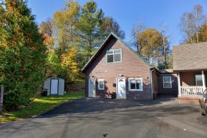 a house with a garage and a driveway at Modern Home &Cozy in Lake Placid