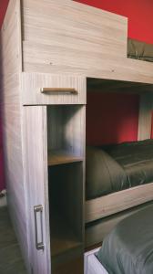 a wooden bunk bed with a bed in it at Hilda House Hostel in Mar del Plata