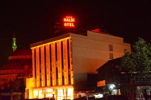 a building with a neon sign on top of it at Haldi Otel in Van