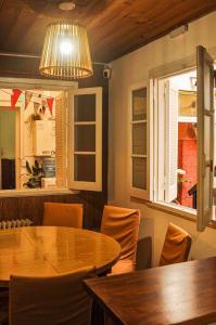 a dining room with a table and chairs and a chandelier at Hilda House Hostel in Mar del Plata