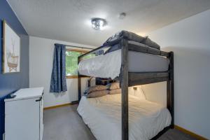 a bedroom with a bunk bed in a room at Hermantown Home with Decks, Grill and Hot Tub! in Hermantown