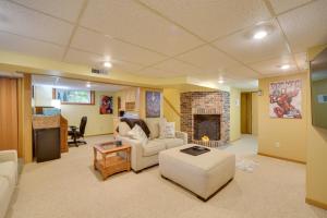 a living room with a couch and a fireplace at Hermantown Home with Decks, Grill and Hot Tub! in Hermantown