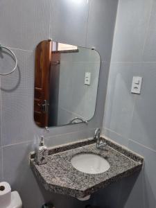 a bathroom with a sink and a mirror at Pousada Talismã in Barreirinhas