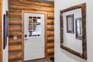 a mirror on a wall next to a door at King's Cabin in West Yellowstone