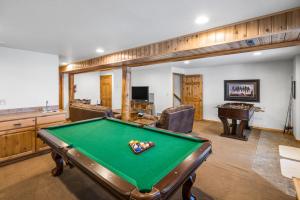 a billiard room with a pool table in it at King's Cabin in West Yellowstone