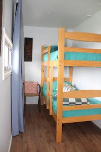 a bunk bed room with two bunk beds and a ladder at Cabaña con fogon y tinaja en plena naturaleza! in Algarrobo