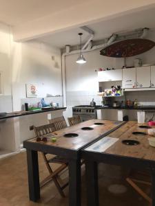 a kitchen with a wooden table and chairs in it at La Maquinita Hostel in Mar del Plata
