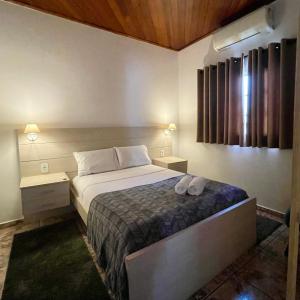 um quarto com uma cama com duas toalhas em Casa Jabuticaba a 5 min dos Thermas e Hot Beach em Olímpia