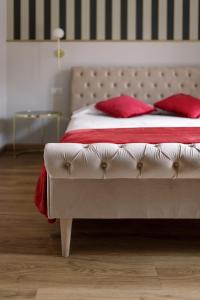 a bedroom with a bed with red pillows on it at Domus 44 Rooms in Verona