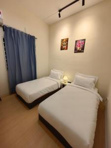 two beds in a small room with at 22A HOSTEL in George Town