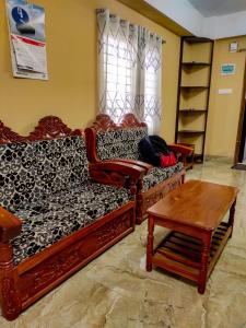 a living room with a couch and a table at Asma-ul-husna apartment in Rājshāhi