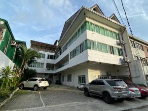 a building with cars parked in front of it at 1-BR spacious lofted apartment near BGC Taguig City (THR105) in Manila