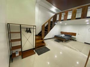a room with a staircase and a bench and a stair case at 1-BR spacious lofted apartment near BGC Taguig City (THR105) in Manila