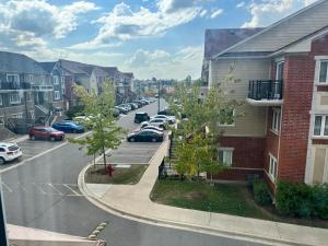 a city street with cars parked in a parking lot at Private, Secure, Immaculate & Cozy Room in Brampton