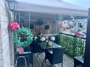 a patio with a table and chairs and flowers at Private, Secure, Immaculate & Cozy Room in Brampton