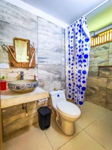 a bathroom with a toilet and a sink at Maria Moñitos Hostel in Moñitos