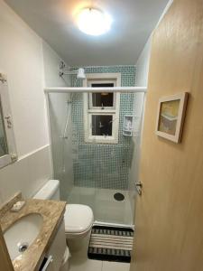 a bathroom with a toilet and a sink and a shower at Esplendor House - Little Cambury in São Sebastião