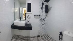 a white bathroom with a sink and a mirror at D'Bangi Home Bandar Baru Bangi in Bandar Baru Bangi