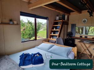 a bedroom with a bed with two backpacks on it at Swiss-Kiwi Retreat in Tauranga