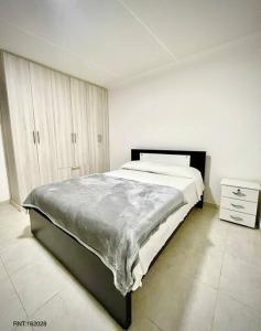 a bedroom with a large bed in a white room at Rincón Familiar-en Corredor Turistico -SRC in Santa Rosa de Cabal