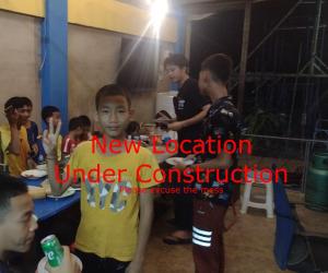 a group of young people standing in a room at Mae Sot Commune in Mae Sot