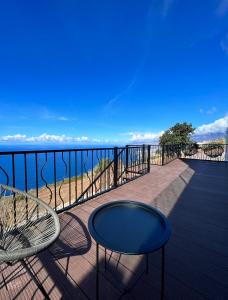 a balcony with two chairs and a table and the ocean at calMar Tenerife 1 in Los Realejos