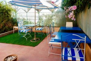 a patio with a table and chairs and an umbrella at CoWork & Stay Suites in Agadir