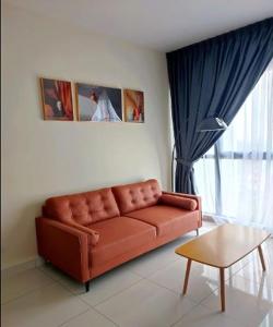 a living room with a brown couch and a window at Mid Vally Southkey JB, 2BR, WIFI, 7 mins to CIQ in Johor Bahru