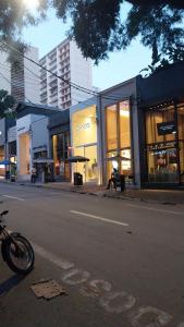 a motorcycle parked on the street in front of a store at Apartamento em São paulo jardins oscar Freire com vaga in Sao Paulo
