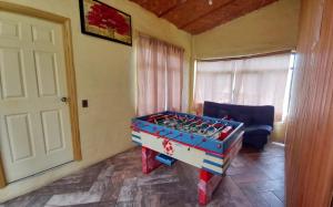 Cabaña “De Aurora” في مازاميتلا: غرفة مع طاولة كرة قدم أمام باب