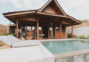 a villa with a swimming pool and a pavilion at Kalyana Villa Gili Air in Gili Air