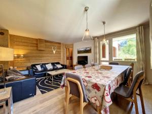 a living room with a table and a couch at Appartement Val-d'Isère, 4 pièces, 8 personnes - FR-1-518-146 in Val-d'Isère