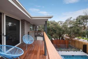a deck with two chairs and a swimming pool at Gawalla Escape with Pool in Rye in Rye