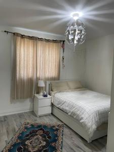 a bedroom with a bed and a chandelier at Mama Gol in Richmond Hill