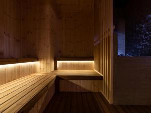 an empty wooden sauna with lights in it at Premier Hotel-CABIN-Sapporo in Sapporo