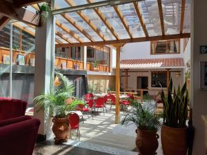 eine Terrasse mit Pflanzen, einem Tisch und Stühlen in der Unterkunft Hotel El Giro in Villa de Leyva