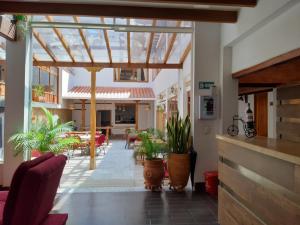 a conservatory with potted plants in a building at Hotel El Giro in Villa de Leyva