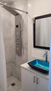 a bathroom with a blue sink and a shower at Mama Gol in Richmond Hill